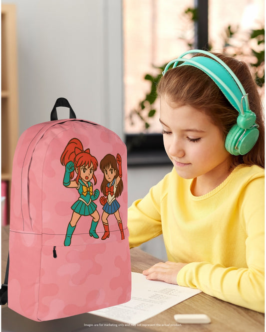 Young school girl wearing teal headphones sitting at a desk with a pink camouflage backpack featuring two anime-style heroines in vibrant uniforms, ideal for back to school.
